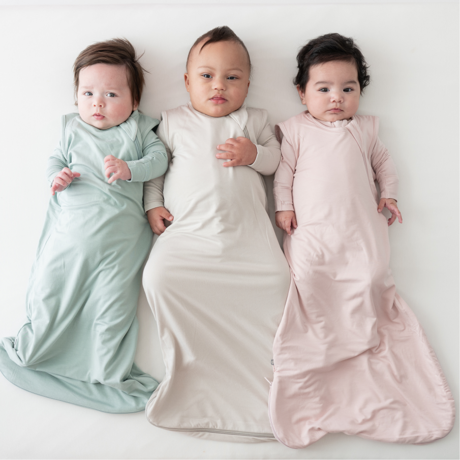 three babies in sleep bags